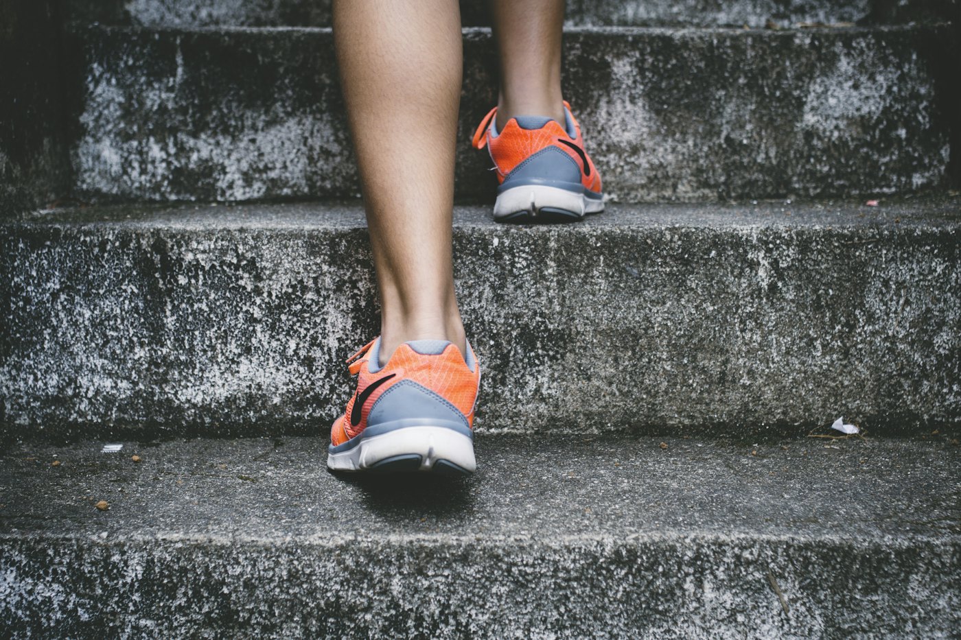 Close-up of running shoes climbing outdoor steps